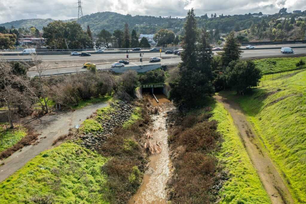 Aerial image of the restoration site on Pinole Creek, W With water flowing through the concrete box culvert, showing water flowing through the concrete box culvert