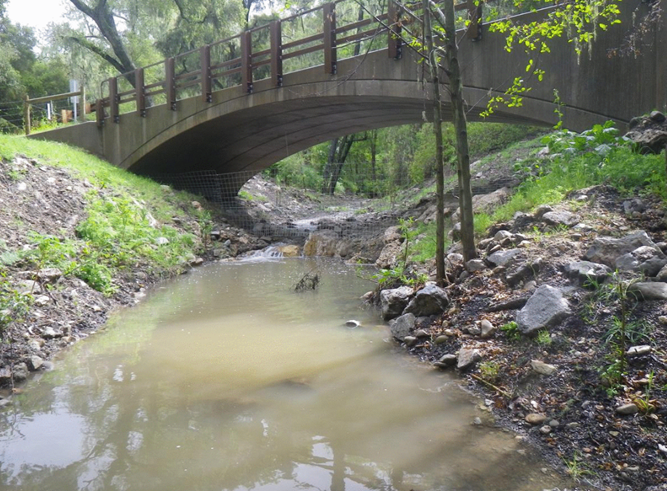 A free spam concrete bridge extends over a waterway